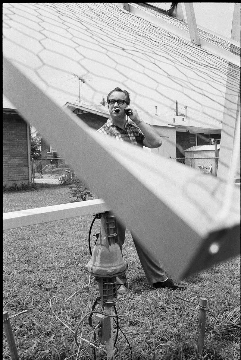Larry Baysinger and the antenna, Louisville, 1969. One story, an open yard, and the frame above the neighbor's roof.